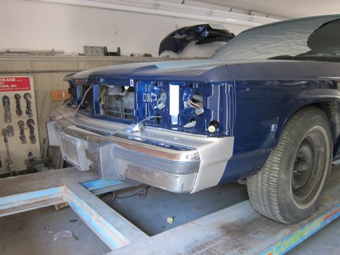 1991 Ford LTD Crown Victoria - Front view of a blue sedan undergoing repairs, missing headlights and grille.