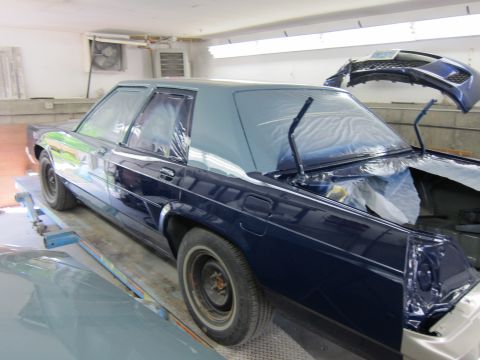 1991 Ford LTD Crown Victoria - A 1991 Ford Crown Victoria is being prepped for paint in a garage, with its hood and trunk open.