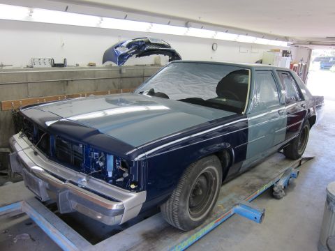 1991 Ford LTD Crown Victoria - A 1991 Ford Crown Victoria LTD is shown in a garage, undergoing paint work.