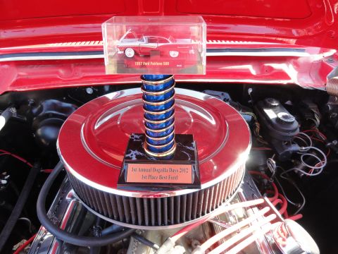 1964 Ford Fairlane - A trophy from the 1st Annual Dogzilla Days 2012 sits in the engine bay of a car.