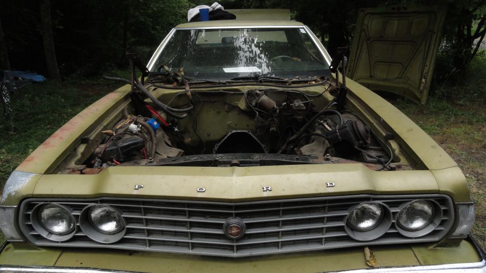 Green 1973 Ford Torino front view, engine bay open, engine removed