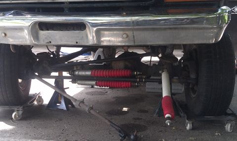 1979 Ford Bronco - Front suspension parts are visible, including shocks and steering linkage, under a chrome bumper.