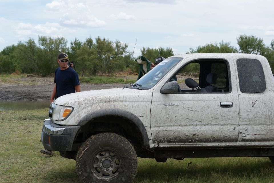 White pickup truck, side view, covered in mud