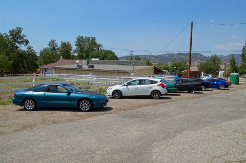 1993 Ford Taurus - A teal coupe is parked in a lot with several other vehicles visible.