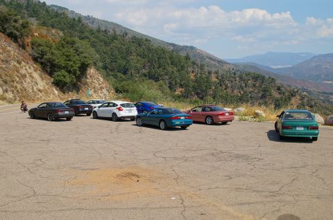 1993 Ford Taurus - A scenic overlook parking area with multiple vehicles gathered on a sunny day.
