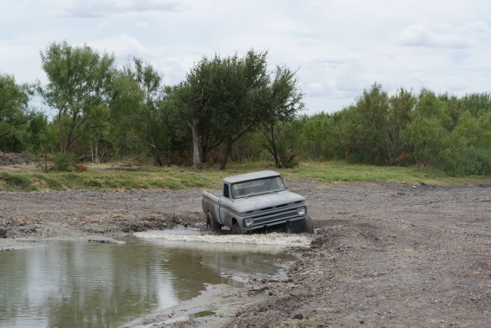 1965 Chevrolet C10 pickup stuck in a muddy puddle off-road