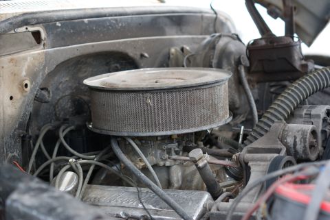1989 Ford Bronco - Close-up view of a vehicle's engine bay, showing the air filter and carburetor assembly.