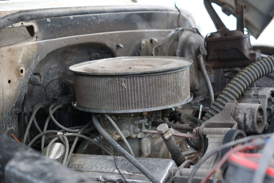 Engine bay with air filter and carburetor visible