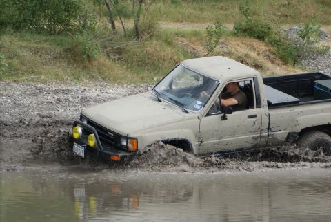 1989 Ford Bronco - This Toyota pickup truck is stuck in the mud while off-roading.