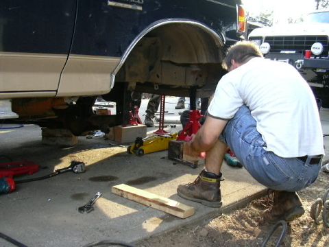 1991 Ford Bronco - Working on the suspension of a 1991 Ford Bronco, with another vehicle in the background.