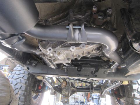 2008 Jeep Wrangler - Underside view of a Jeep's modified exhaust system and transmission housing.