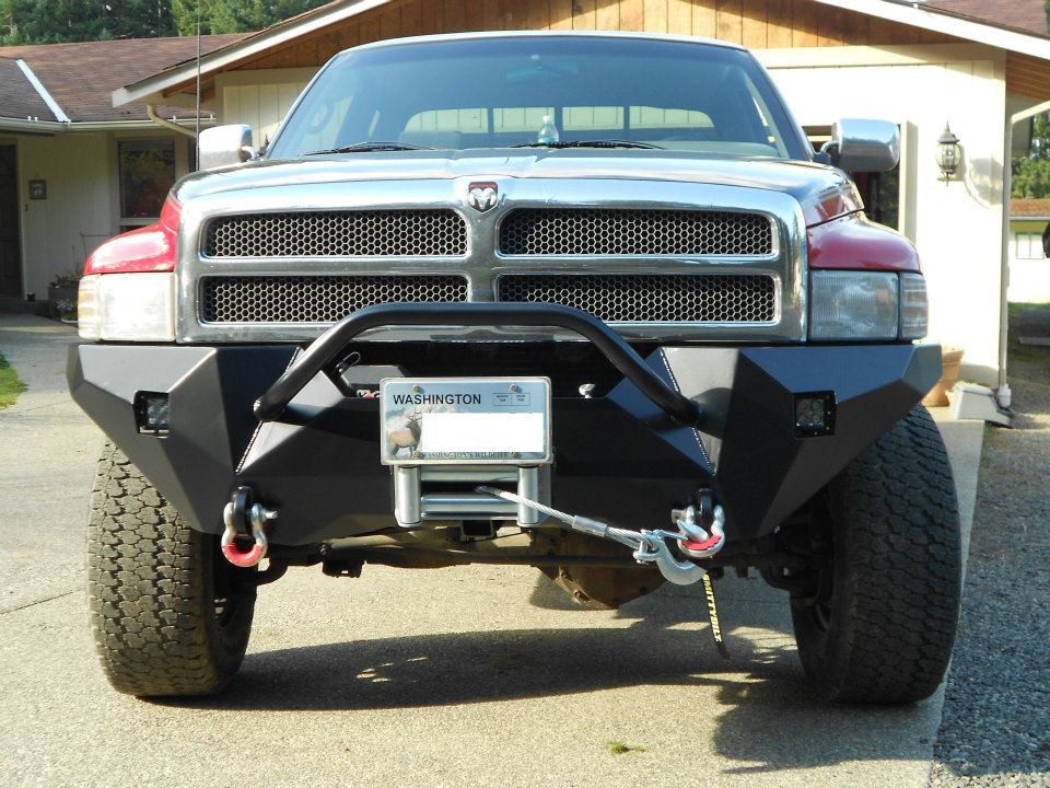Front view of a Dodge Ram truck with an aftermarket bumper, winch, and tow hooks. Washington license plate visible