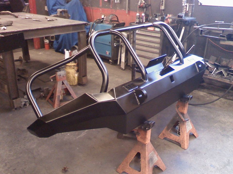 Black custom bumper with roll cage on jack stands