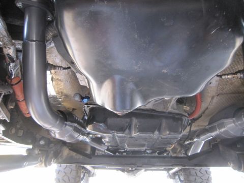 2008 Jeep Wrangler - This photo shows the undercarriage of a vehicle, focusing on the transmission and exhaust system components.