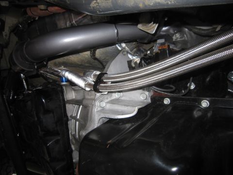 2008 Jeep Wrangler - Custom exhaust and braided lines visible on the underside of an engine and transmission assembly.