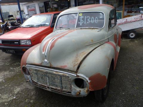 1969 Lincoln Continental - This old car is for sale for $1300, parked next to a red Nissan with a trailer behind it.