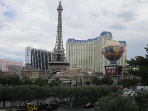 1991 Ford LTD Crown Victoria - View of the Las Vegas Strip the Eiffel Tower replica and Paris Las Vegas hotel under a cloudy sky.