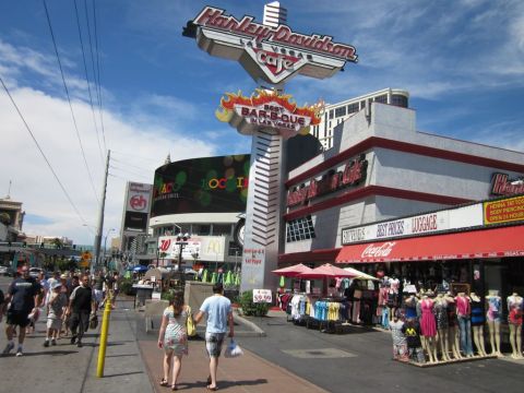 1991 Ford LTD Crown Victoria - A busy street scene in Las Vegas with the iconic Harley-Davidson Cafe sign prominently displayed.