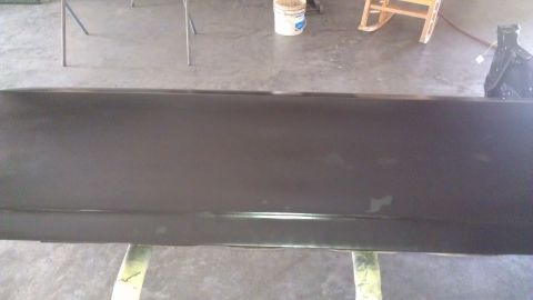 1973 Chevrolet Camaro - A car door is prepared for painting in an indoor setting.