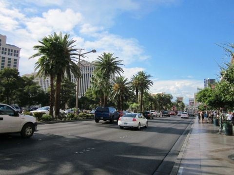 1991 Ford LTD Crown Victoria - A sunny day on the Las Vegas Strip features traffic, pedestrians, and iconic hotels.