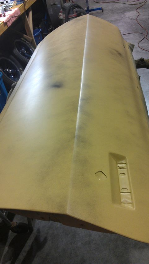 1973 Chevrolet Camaro - Primer-coated car hood, likely undergoing restoration or repair work.