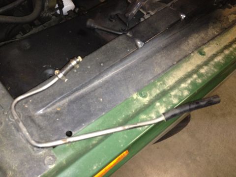 1978 Ford Bronco - A close-up view of a metal tube and its fittings, likely part of the vehicle's fluid system.