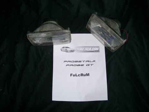 1995 Ford Probe - Two clear plastic fog lights are displayed with a document referencing Probetalk and Probe GT.