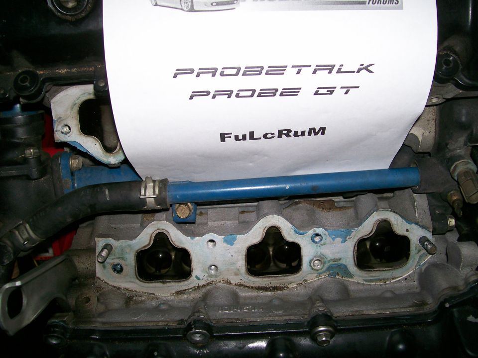 Engine manifold with paper showing 'PROBETALK PROBE GT' and 'FuLcRuM'
