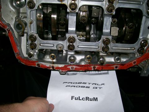 1995 Ford Probe - Close-up view of an engine block, with a paper indicating 'PROBETALK PROBE GT' held in front.