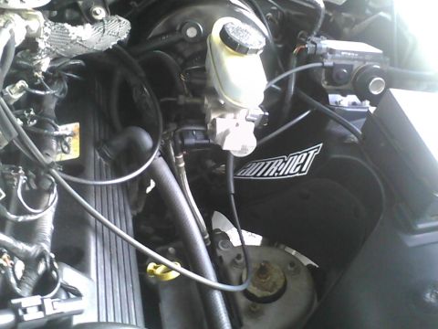 2003 Ford Crown Victoria - Close-up view of engine bay components including the brake fluid reservoir and air intake.