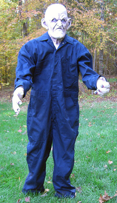 1989 Ford Bronco - A mannequin dressed as a scary character stands outdoors in a blue jumpsuit.
