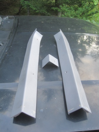 1993 Ford Bronco - These automotive trim pieces are laid out on the hood of a vehicle.