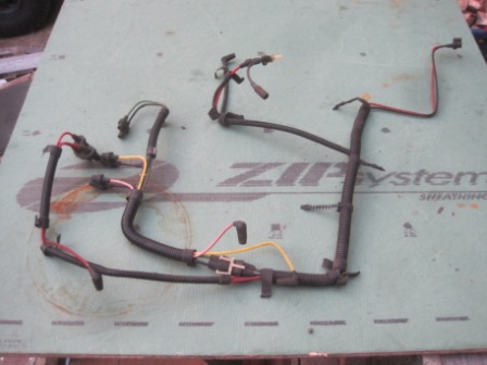 1993 Ford Bronco - A vehicle wiring harness is shown on a surface with some text printed on it.
