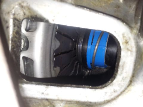 1994 Ford Ranger - A mechanical part with blue banding is visible through a metal housing opening.