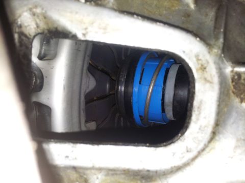 1994 Ford Ranger - A close-up view of a mechanical component blue and black plastic pieces and a metal spring.