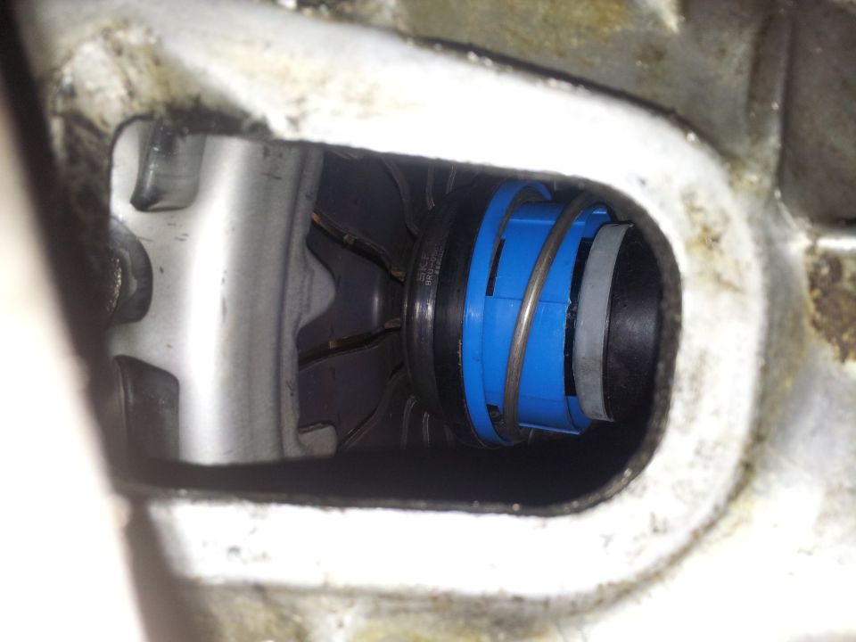 Close-up of a blue and black mechanical part with a spring