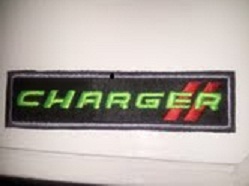 2012 Dodge Charger - Close-up of a Charger III emblem.