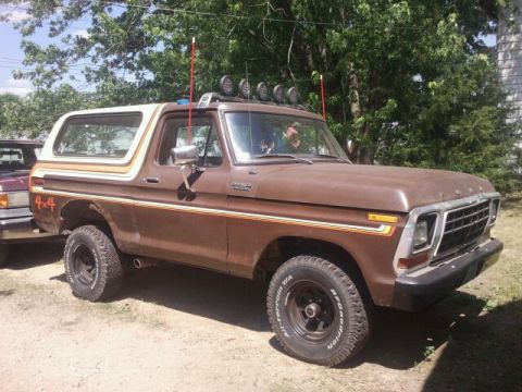 1979 Ford Bronco - This 1978 Ford Bronco features a two-tone paint scheme with racing stripes and a prominent 4x4 decal on the rear fender.