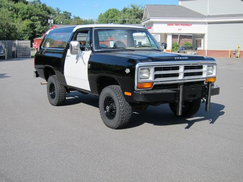 1987 Dodge 1500 - This two-tone Dodge Ramcharger is parked in front of a building with a drive-thru pharmacy.