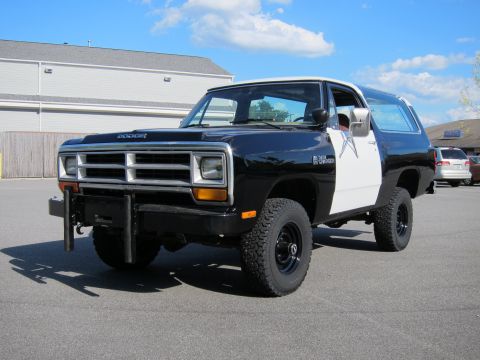 1987 Dodge 1500 - This two-tone Dodge Ramcharger is parked outside on a sunny day.