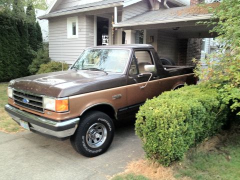 1991 Ford Bronco - This two-tone brown 1991 Ford Bronco is parked in front of a house.