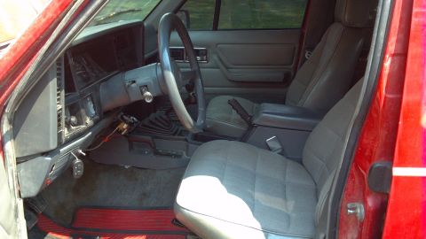 1995 Jeep Cherokee - Interior view of a 1995 Jeep Cherokee, highlighting the driver and passenger seats and dashboard.