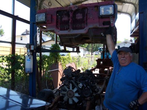 1987 Ford Ranger - A man poses with a vehicle's front end and engine assembly being worked on.