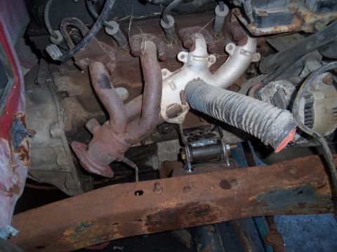 1987 Ford Ranger - Close-up view of engine exhaust manifold and associated parts, showing signs of wear and rust.