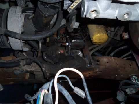 1987 Ford Ranger - Close-up view of engine components including the starter motor and oil filter.
