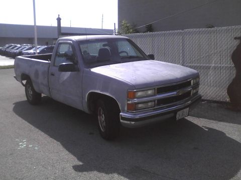 2003 Ford Crown Victoria - This light blue pickup truck, likely from the mid-1990s, is shown from a 3q front angle. The license plate is visible.