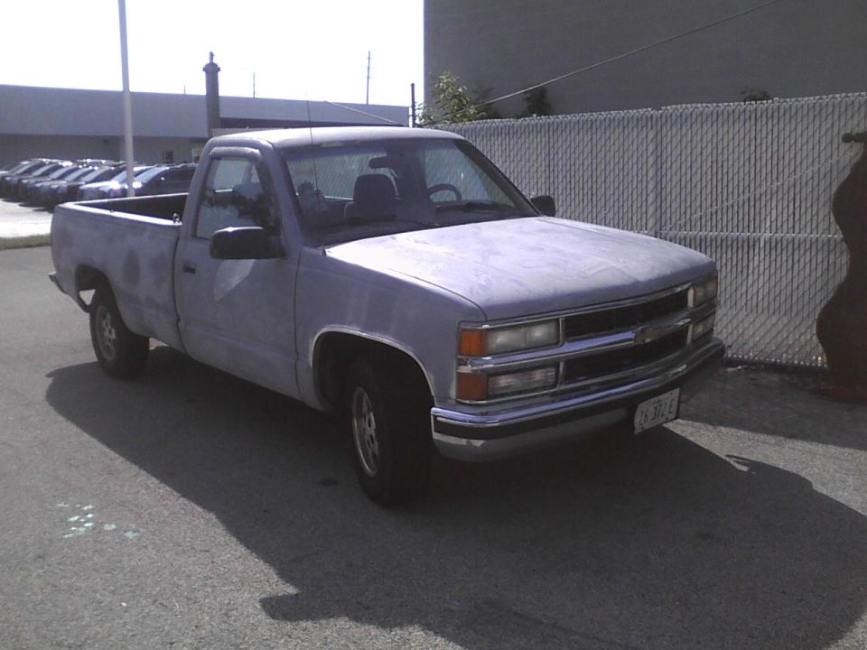 Light blue pickup truck, 3q front view. License plate reads 630-FE