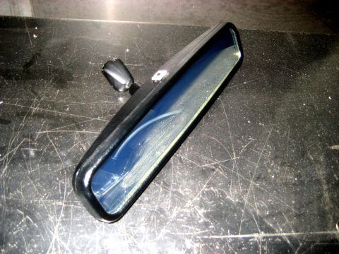 1996 Ford Bronco - Interior rear-view mirror shown on a scratched surface.