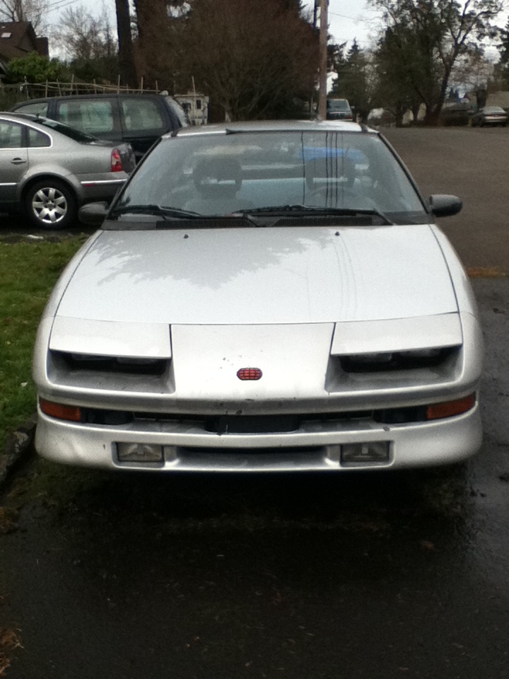 Silver Geo Storm coupe, front view with pop-up headlights closed