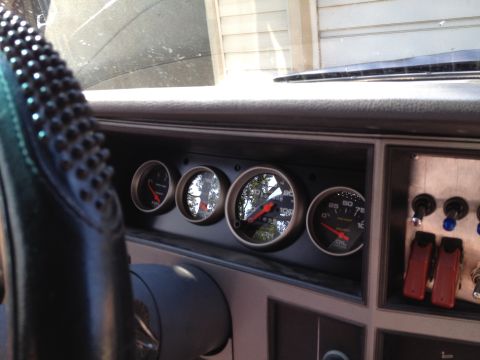 1988 Ford Bronco - Interior view of a vehicle's dashboard, displaying multiple gauges and switches.